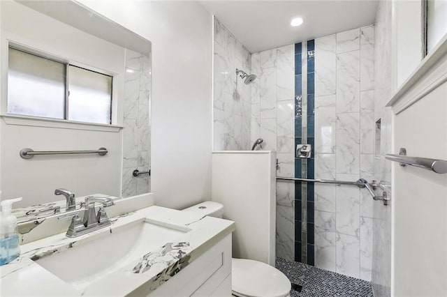 full bathroom with toilet, a stall shower, and vanity