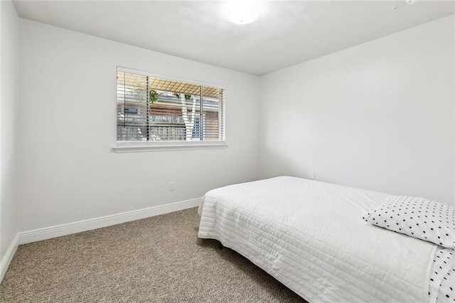 bedroom with carpet flooring and baseboards