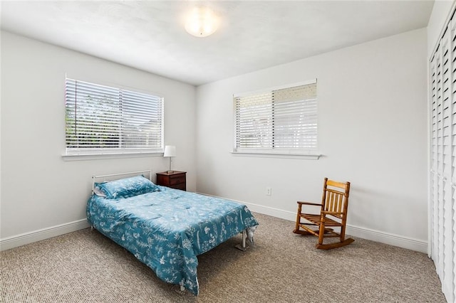 carpeted bedroom with baseboards