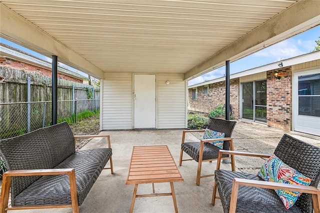 view of patio with outdoor lounge area and fence