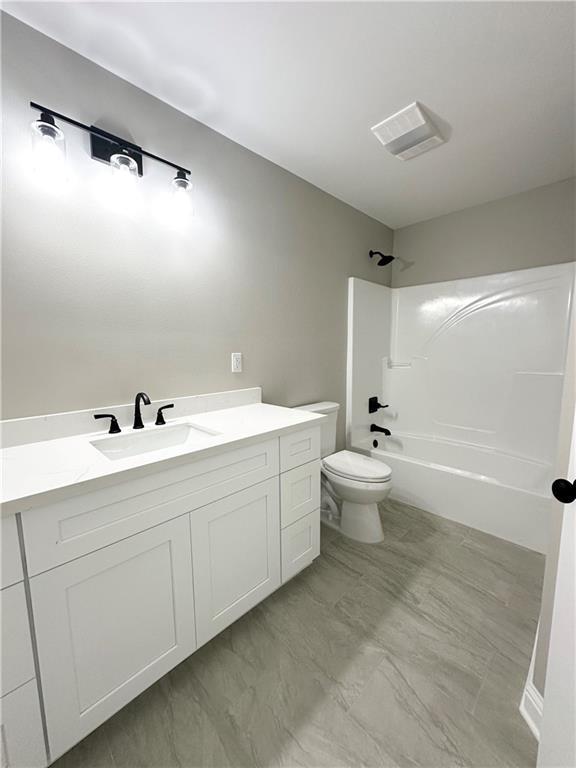 bathroom featuring visible vents,  shower combination, vanity, and toilet