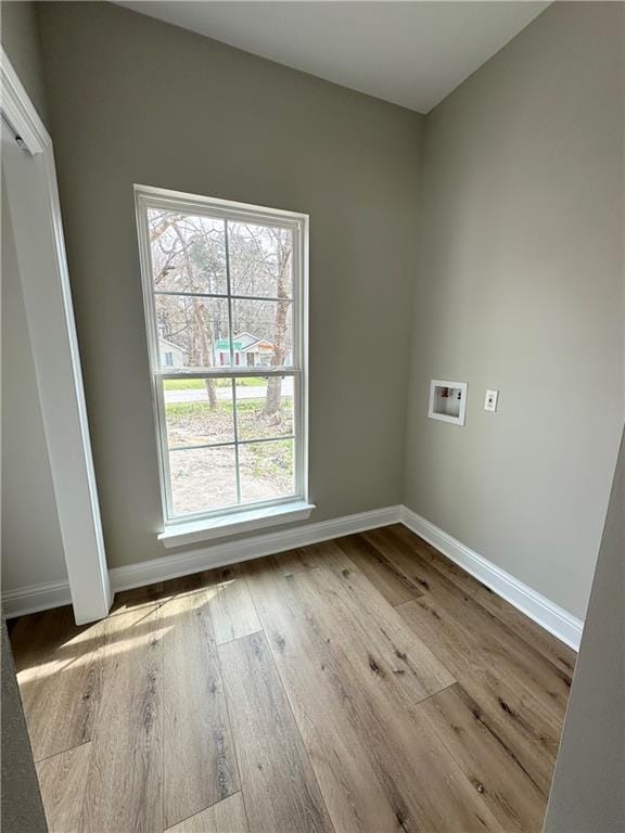 unfurnished room with baseboards and wood finished floors