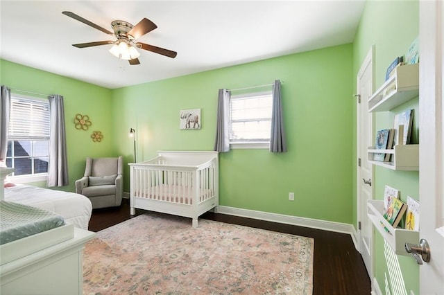 bedroom with ceiling fan, baseboards, and wood finished floors