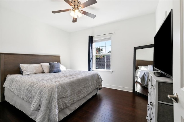 bedroom featuring ceiling fan, baseboards, and dark wood-style flooring