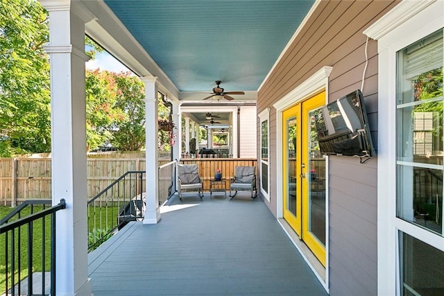 view of patio / terrace with french doors, ceiling fan, and fence