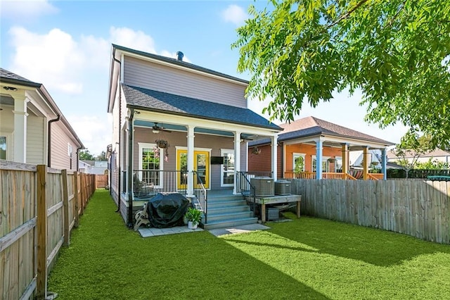 back of house featuring a wooden deck, a yard, a fenced backyard, and ceiling fan