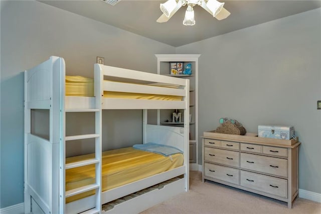 bedroom with baseboards, a ceiling fan, and light colored carpet