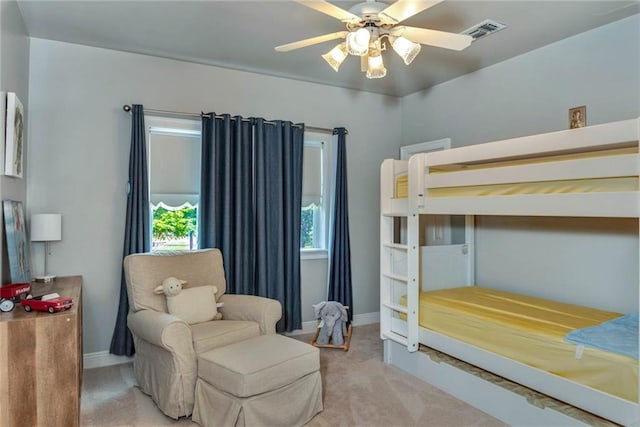 bedroom with carpet floors, visible vents, baseboards, and a ceiling fan