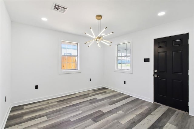 foyer featuring a healthy amount of sunlight, visible vents, wood finished floors, and recessed lighting