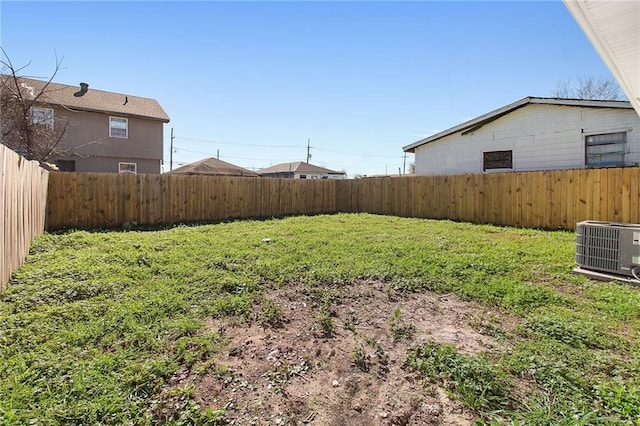 view of yard featuring a fenced backyard and central air condition unit