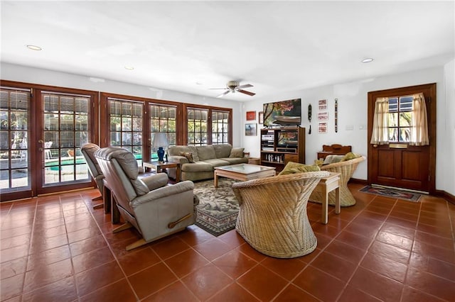 living area featuring recessed lighting, baseboards, dark tile patterned flooring, and a ceiling fan