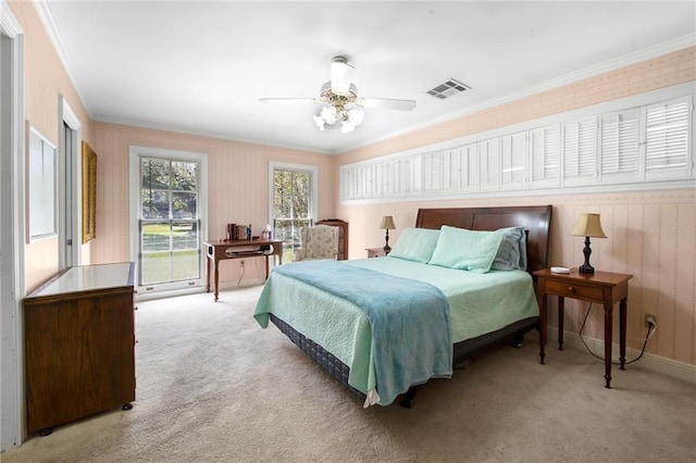 carpeted bedroom featuring visible vents, ceiling fan, and ornamental molding