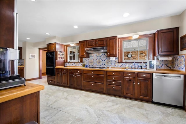 kitchen featuring under cabinet range hood, decorative backsplash, appliances with stainless steel finishes, and a sink