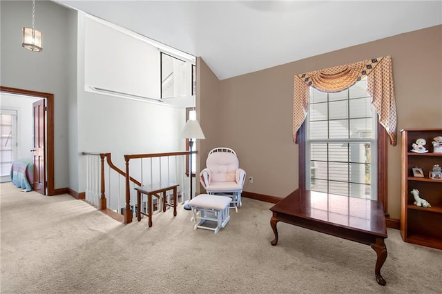 sitting room with a wealth of natural light, baseboards, carpet, and high vaulted ceiling