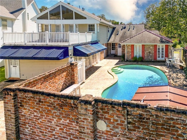 view of pool with a fenced in pool, french doors, and a patio