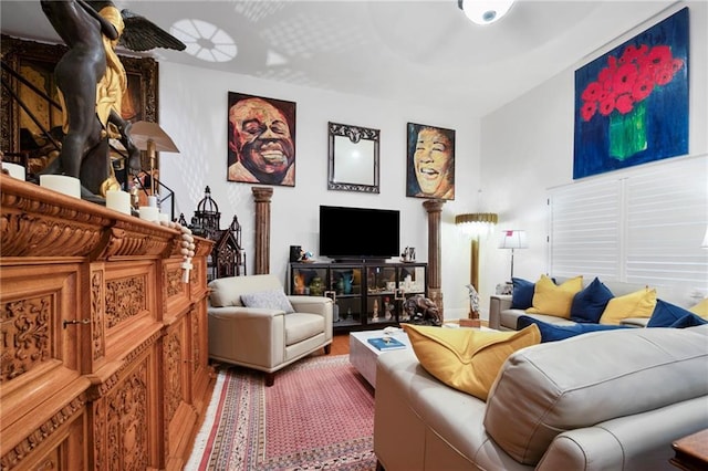 living area featuring a ceiling fan and wood finished floors