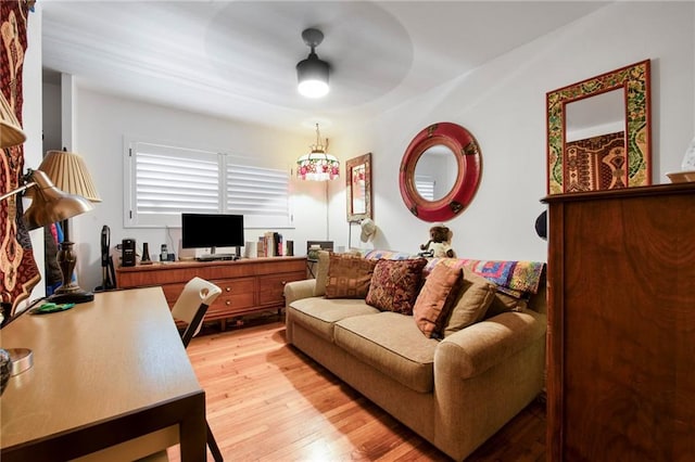 living area featuring light wood-style floors and ceiling fan