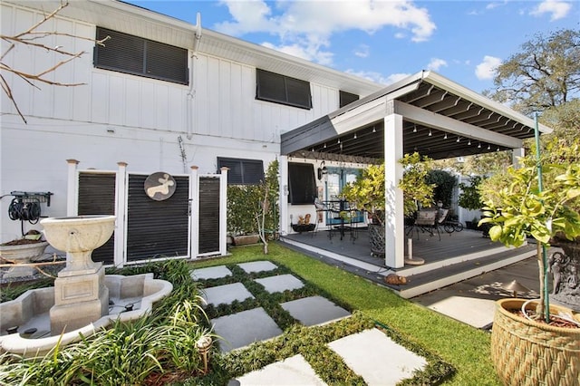 back of property with a gazebo and a wooden deck