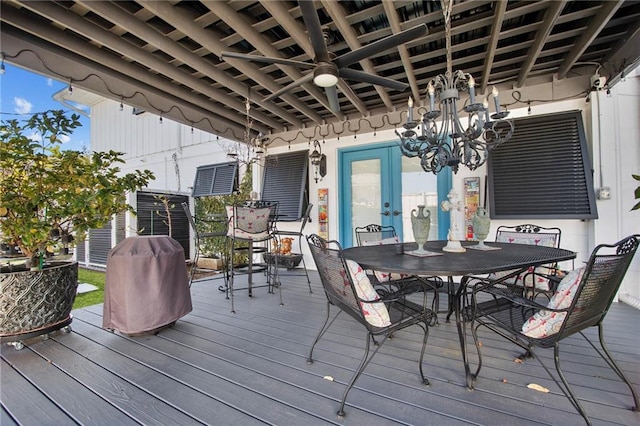 wooden terrace with outdoor dining space and ceiling fan