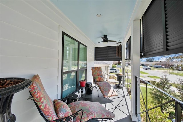 balcony with covered porch and a ceiling fan