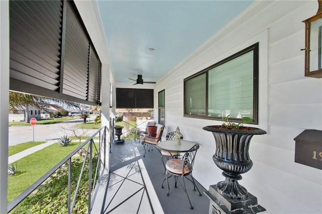 balcony featuring a ceiling fan and covered porch