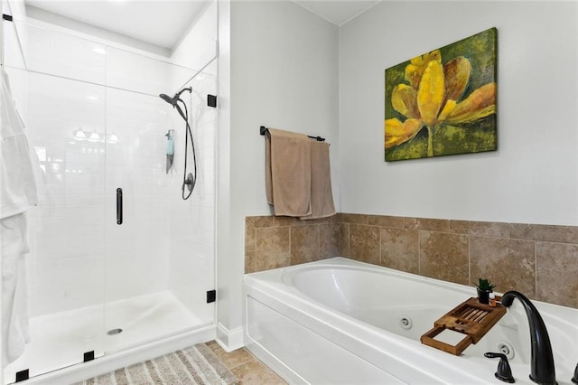 full bathroom with tile patterned flooring, a shower stall, and a jetted tub