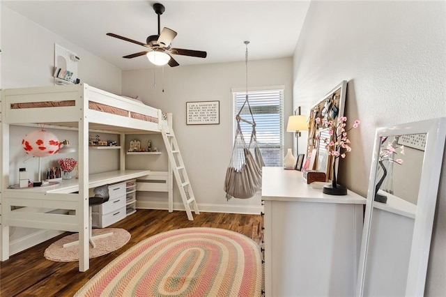 bedroom featuring ceiling fan, baseboards, and wood finished floors