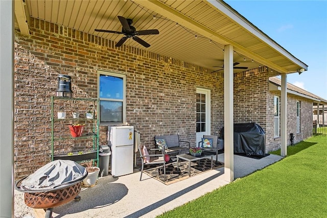 view of patio with area for grilling and a ceiling fan