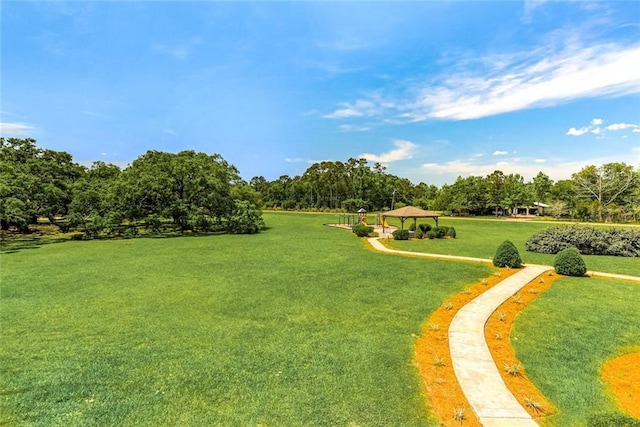 view of property's community with a gazebo and a yard