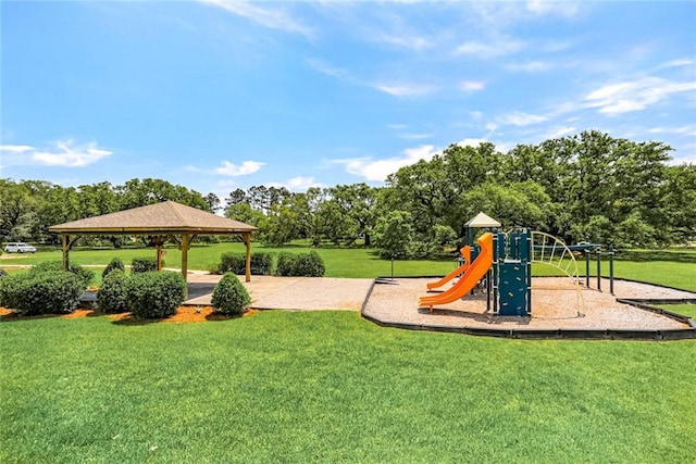 communal playground featuring a gazebo and a lawn