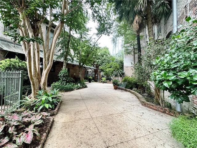 view of community with fence and a patio area