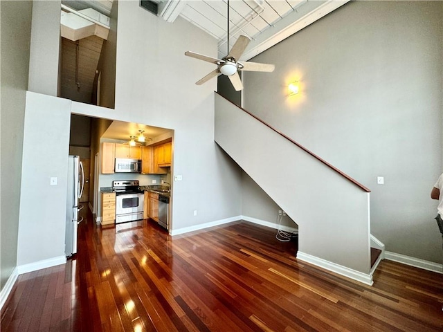 unfurnished living room with baseboards, dark wood-style floors, and stairs