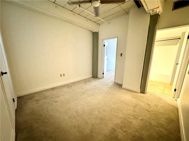 unfurnished bedroom with baseboards and light carpet