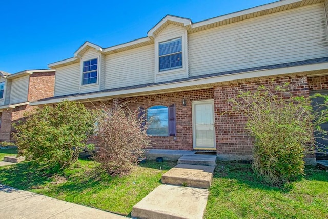 townhome / multi-family property featuring brick siding