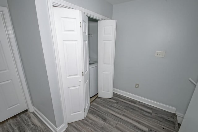 unfurnished bedroom featuring baseboards and dark wood-style flooring