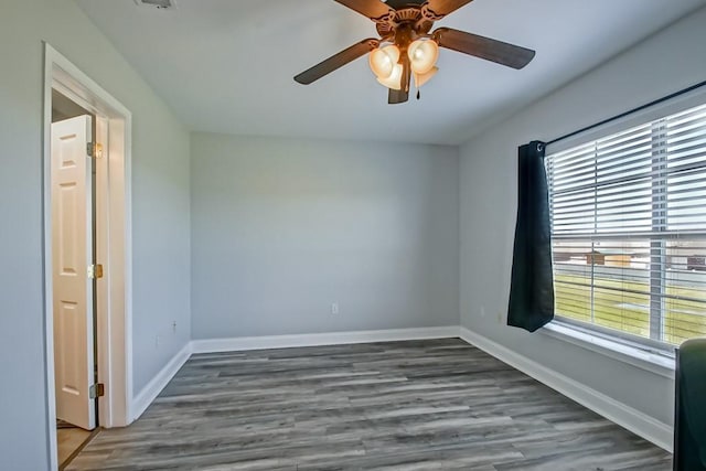 unfurnished room featuring ceiling fan, baseboards, and wood finished floors