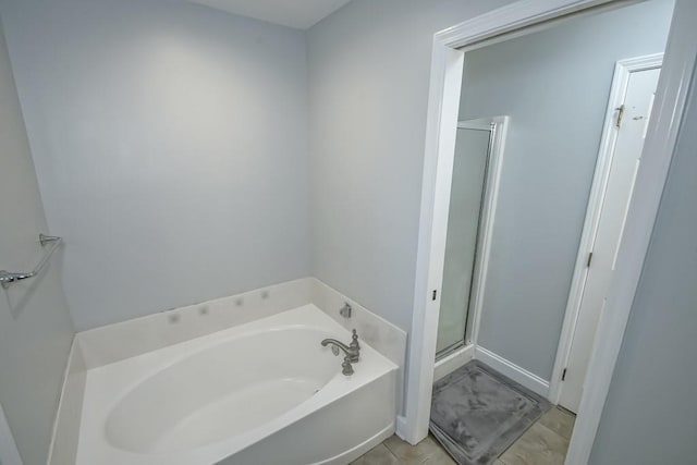 full bath featuring a bath and a shower stall