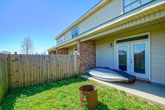 view of yard with fence and french doors