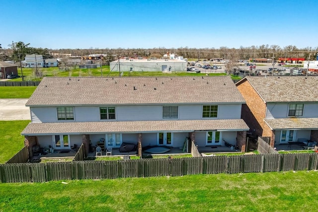 back of house with a lawn, a patio, and a fenced backyard