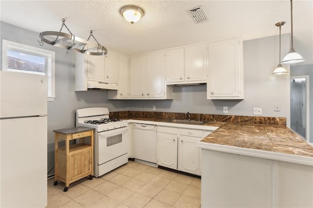 kitchen with under cabinet range hood, a peninsula, white appliances, white cabinetry, and a sink