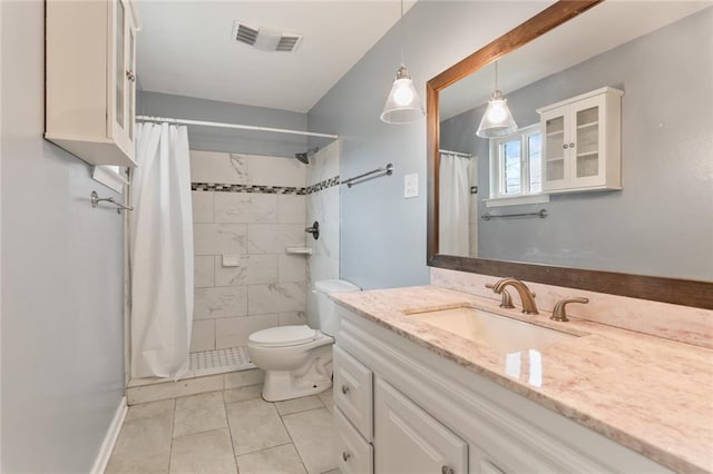 full bath with visible vents, tiled shower, toilet, and vanity