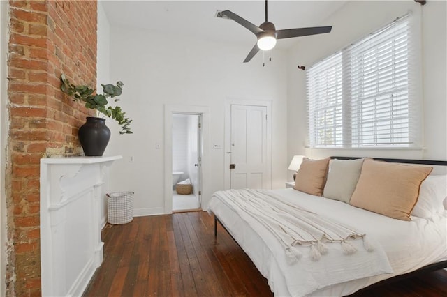 unfurnished bedroom with baseboards, a high ceiling, ensuite bath, a ceiling fan, and wood-type flooring