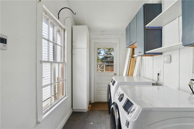 washroom featuring laundry area, washing machine and dryer, baseboards, and a wealth of natural light