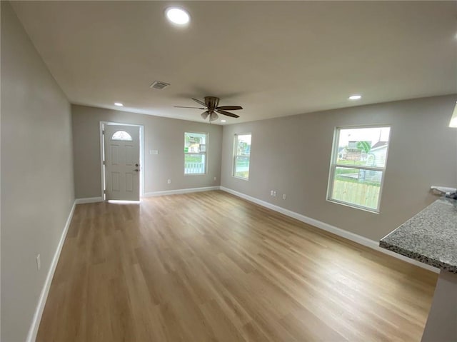 4612 Majestic Oaks Dr, New Orleans, LA 70126 - unfurnished living room featuring light wood finished floors, baseboards, visible vents, and recessed lighting