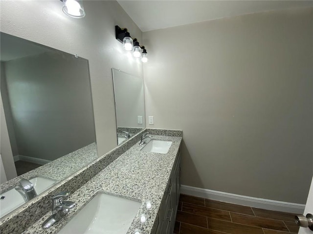 4612 Majestic Oaks Dr, New Orleans, LA 70126 - full bathroom with a sink, baseboards, double vanity, and wood finish floors