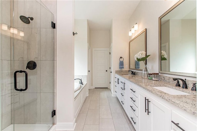 full bath featuring a sink, a garden tub, a stall shower, and double vanity