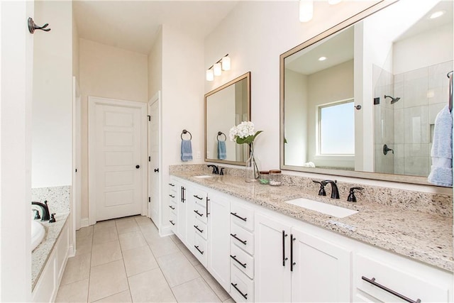 full bathroom with a sink, double vanity, a stall shower, and tile patterned floors