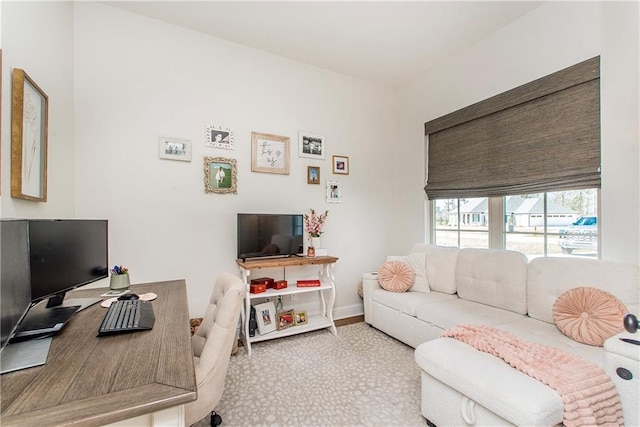 carpeted home office with baseboards