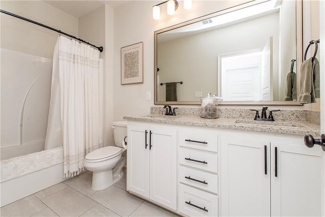 full bath with tile patterned floors, toilet, double vanity, and a sink