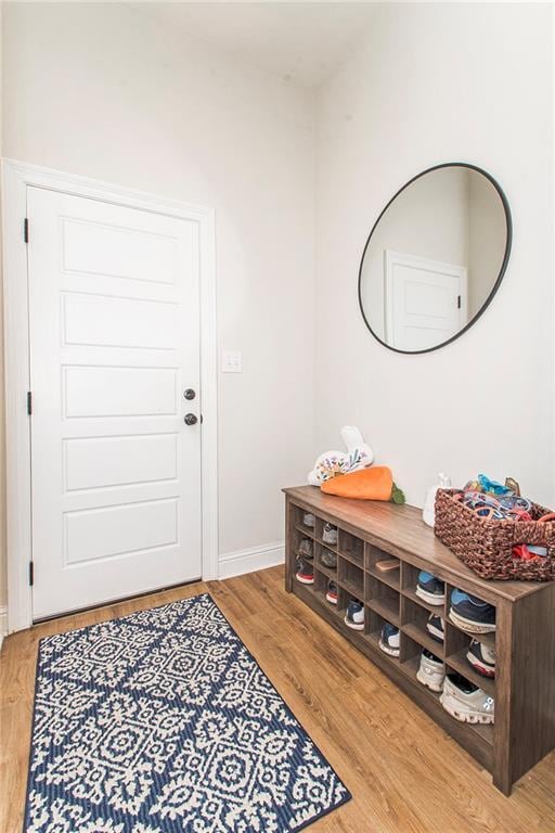 mudroom featuring light wood-style flooring and baseboards